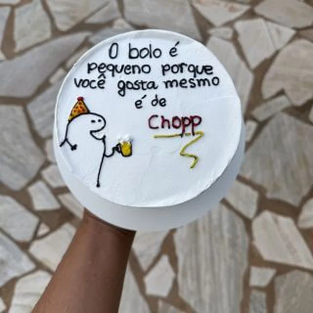 Bolo branco com desenho de bonequinho e escrita bem-humorada sobre chopp